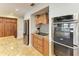 Gourmet kitchen with stainless steel oven, modern backsplash, custom hood, and wooden cabinetry provides an elegant cooking space at 200 Capri Isles Ct, Punta Gorda, FL 33950