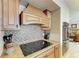 Modern kitchen featuring granite countertops, stainless steel ovens, and a decorative tile backsplash at 200 Capri Isles Ct, Punta Gorda, FL 33950