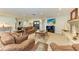 Spacious living room with comfortable seating, a fireplace, and a large television for entertainment at 200 Capri Isles Ct, Punta Gorda, FL 33950