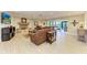 Spacious living room featuring a stone fireplace and large windows offering natural light at 200 Capri Isles Ct, Punta Gorda, FL 33950