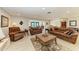 Bright living room with ample seating, large windows, and stylish decor for a cozy atmosphere at 200 Capri Isles Ct, Punta Gorda, FL 33950