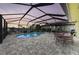 Relaxing screened pool area with a waterfront view, pavers, and outdoor seating perfect for entertaining guests at 200 Capri Isles Ct, Punta Gorda, FL 33950