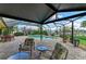 Screened lanai featuring a pool, waterfront view, comfortable seating, and lush landscaping perfect for relaxation at 200 Capri Isles Ct, Punta Gorda, FL 33950