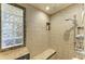 Modern shower with tiled walls, glass block window, and built-in niche at 200 Capri Isles Ct, Punta Gorda, FL 33950