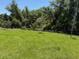 The property features a flat backyard and lush greenery at 20241 Lorette Ave, Port Charlotte, FL 33954
