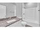 Bathroom featuring granite counters, double sinks, and a shower-tub combination at 20241 Lorette Ave, Port Charlotte, FL 33954