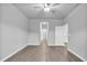 Spacious bedroom boasts a ceiling fan and light gray walls complemented by wood-look flooring at 20241 Lorette Ave, Port Charlotte, FL 33954