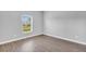 Bright bedroom features a window and neutral walls complemented by modern wood-look flooring at 20241 Lorette Ave, Port Charlotte, FL 33954
