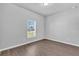 Bright bedroom features a window and neutral walls complemented by modern wood-look flooring at 20241 Lorette Ave, Port Charlotte, FL 33954