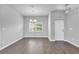 Dining area with hardwood floors, modern lighting and a large window with a view of the outdoors at 20241 Lorette Ave, Port Charlotte, FL 33954