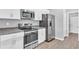 Modern kitchen with stainless steel appliances, white cabinets, and stone countertops at 20241 Lorette Ave, Port Charlotte, FL 33954