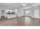 Open-concept living space featuring hardwood floors, modern lighting, and a view of the kitchen at 20241 Lorette Ave, Port Charlotte, FL 33954
