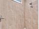 Tiled shower with brushed nickel fixtures and light from a window at 20241 Lorette Ave, Port Charlotte, FL 33954