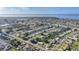 Extensive aerial view featuring a waterfront community with numerous houses and canals against a coastal backdrop at 21249 Higgs Dr, Port Charlotte, FL 33952