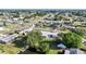 Wide aerial shot of a home located in a neighborhood with a canal and lush greenery nearby at 21249 Higgs Dr, Port Charlotte, FL 33952
