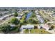 An aerial view showcasing the house near waterways with lush greenery and neighborhood streets at 21249 Higgs Dr, Port Charlotte, FL 33952