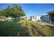 Expansive backyard with mature trees, access to the water and a patio; serene outdoor space at 21249 Higgs Dr, Port Charlotte, FL 33952