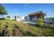Expansive backyard features a covered patio, hot tub, and well-maintained lawn for outdoor enjoyment at 21249 Higgs Dr, Port Charlotte, FL 33952