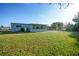Lush backyard featuring an enclosed patio, perfect for outdoor gatherings at 21249 Higgs Dr, Port Charlotte, FL 33952