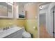 Well-lit bathroom with a tiled backsplash and a view into the hall at 21249 Higgs Dr, Port Charlotte, FL 33952