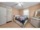Comfortable bedroom with a double bed, a closet and a dresser with a decorative mirror at 21249 Higgs Dr, Port Charlotte, FL 33952