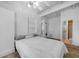 Bright bedroom featuring white walls, ceiling fan, and an ensuite bath at 21249 Higgs Dr, Port Charlotte, FL 33952