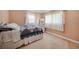 Bright bedroom featuring a double bed, carpet and a dresser with a decorative mirror at 21249 Higgs Dr, Port Charlotte, FL 33952