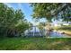 Picturesque waterfront view with a private wooden dock extending into the tranquil canal at 21249 Higgs Dr, Port Charlotte, FL 33952