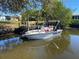 Scenic view of a private dock and boat, perfect for enjoying waterfront living and outdoor activities at 21249 Higgs Dr, Port Charlotte, FL 33952