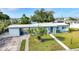Beautiful home featuring a well-manicured lawn, convenient carport, and decorative front door entrance at 21249 Higgs Dr, Port Charlotte, FL 33952