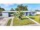 Inviting home with a convenient carport, well-manicured lawn, and a decorative front door entrance at 21249 Higgs Dr, Port Charlotte, FL 33952