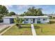 Inviting single-story home with a well-maintained lawn and decorative front accents at 21249 Higgs Dr, Port Charlotte, FL 33952