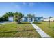 A well-kept home with a vibrant lawn, providing a welcoming curb appeal at 21249 Higgs Dr, Port Charlotte, FL 33952