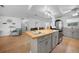Open kitchen with a large island, seating, updated appliances, and a seamless flow into the living area at 21249 Higgs Dr, Port Charlotte, FL 33952