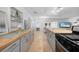 Open kitchen with butcher block countertops, stainless steel appliances, and a view into the adjacent living area at 21249 Higgs Dr, Port Charlotte, FL 33952