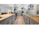 Spacious kitchen showcasing updated gray cabinets, butcher block countertops, and stainless steel appliances at 21249 Higgs Dr, Port Charlotte, FL 33952
