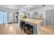 Bright kitchen featuring an island with bar seating, stainless steel appliances, and ample counter space at 21249 Higgs Dr, Port Charlotte, FL 33952