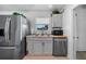 Efficient kitchen design featuring gray cabinets, stainless steel appliances, and a functional layout at 21249 Higgs Dr, Port Charlotte, FL 33952