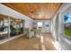 Bright sunroom with a wood plank ceiling, tile floor, and a view into the adjacent living space at 21249 Higgs Dr, Port Charlotte, FL 33952