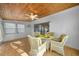 Cozy sunroom featuring tile flooring, a wood-paneled ceiling, and ample natural light from large windows at 21249 Higgs Dr, Port Charlotte, FL 33952