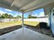 Covered patio overlooking the spacious backyard with lush greenery and a white fence at 2600 Mohegan Rd, Venice, FL 34293