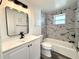 Stylish bathroom with modern fixtures and marble-like tile accent wall over the bathtub at 2600 Mohegan Rd, Venice, FL 34293