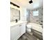 Updated bathroom showcasing a modern vanity, sleek fixtures, and tiled bathtub with shower at 2600 Mohegan Rd, Venice, FL 34293