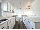 Modern kitchen featuring white cabinets, a breakfast bar, and sleek countertops, offering ample space at 2600 Mohegan Rd, Venice, FL 34293