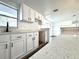 Modern kitchen featuring white cabinets and luxury gray and white countertops at 2600 Mohegan Rd, Venice, FL 34293