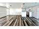 Open-concept living area with wood floors seamlessly connects the living room and kitchen at 2600 Mohegan Rd, Venice, FL 34293