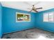 Bright blue bedroom featuring a classic ceiling fan and large windows at 2677 Martin St, Sarasota, FL 34237