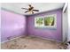 Bedroom with a classic ceiling fan and large window overlooking the yard at 2677 Martin St, Sarasota, FL 34237