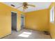 View of the bedroom's layout, featuring a ceiling fan and multiple doorways at 2677 Martin St, Sarasota, FL 34237