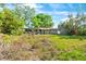 Front exterior of a home with lawn, brimming with potential to renovate at 2677 Martin St, Sarasota, FL 34237